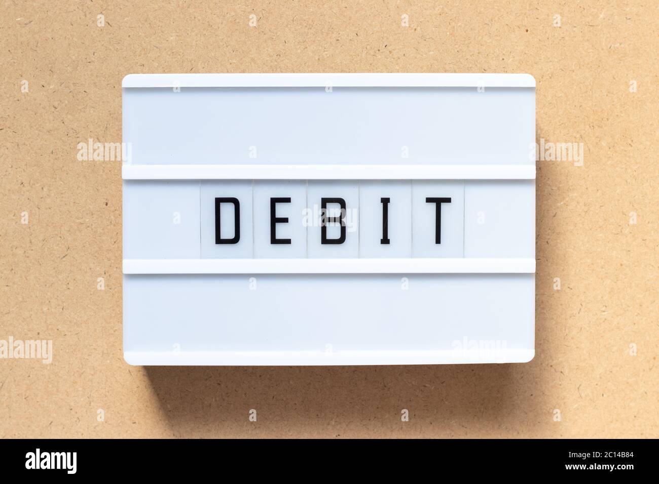 White lightbox with word debit on wood background Stock Photo