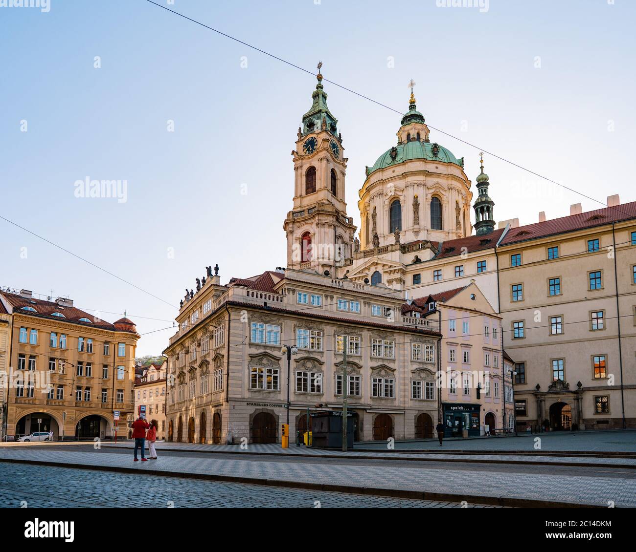 Coronavirus pandemic. Mala Strana, Prague, during coronavirus almost deserted streets on a sunny. St. Nicholas church seen in the background Stock Photo