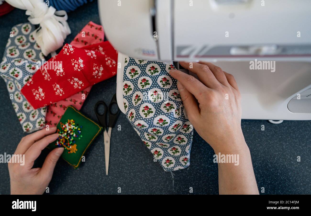 Top view concept of young woman making home made breathing mask, corona ...