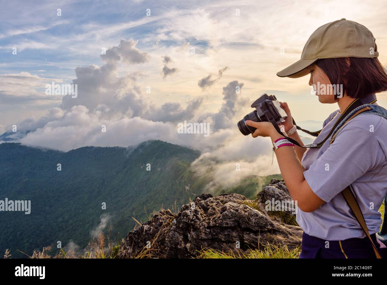 Hiker girl looking photo on camera Stock Photo