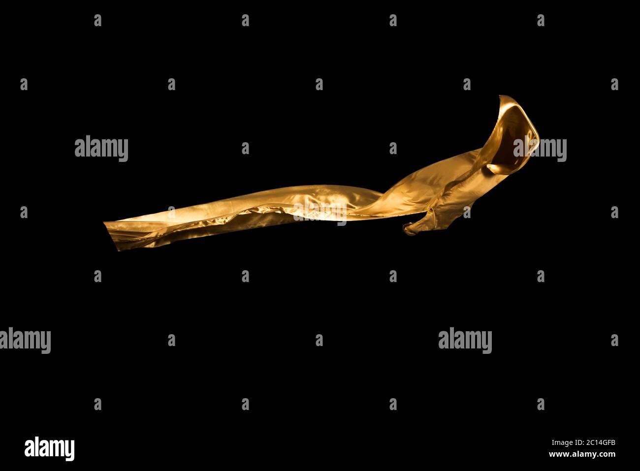 golden soft satin flying in wind on background Stock Photo