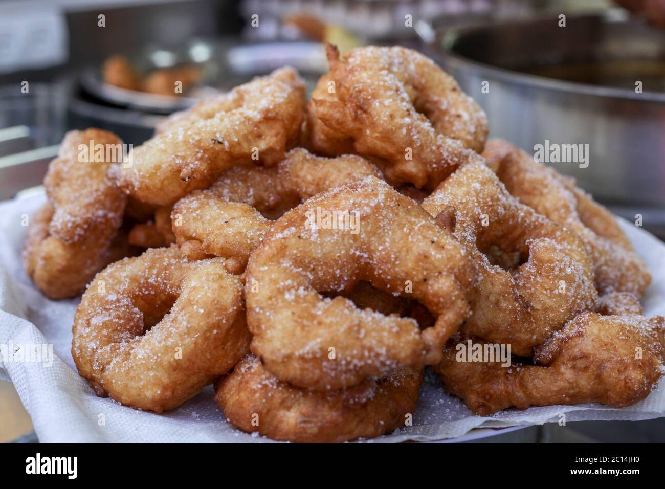 Freshly fried Sfenj a Maghrebi doughnut: a light, spongy ring of dough fried in oil. Sfenj is eaten plain, sprinkled with sugar, or soaked in honey. Stock Photo