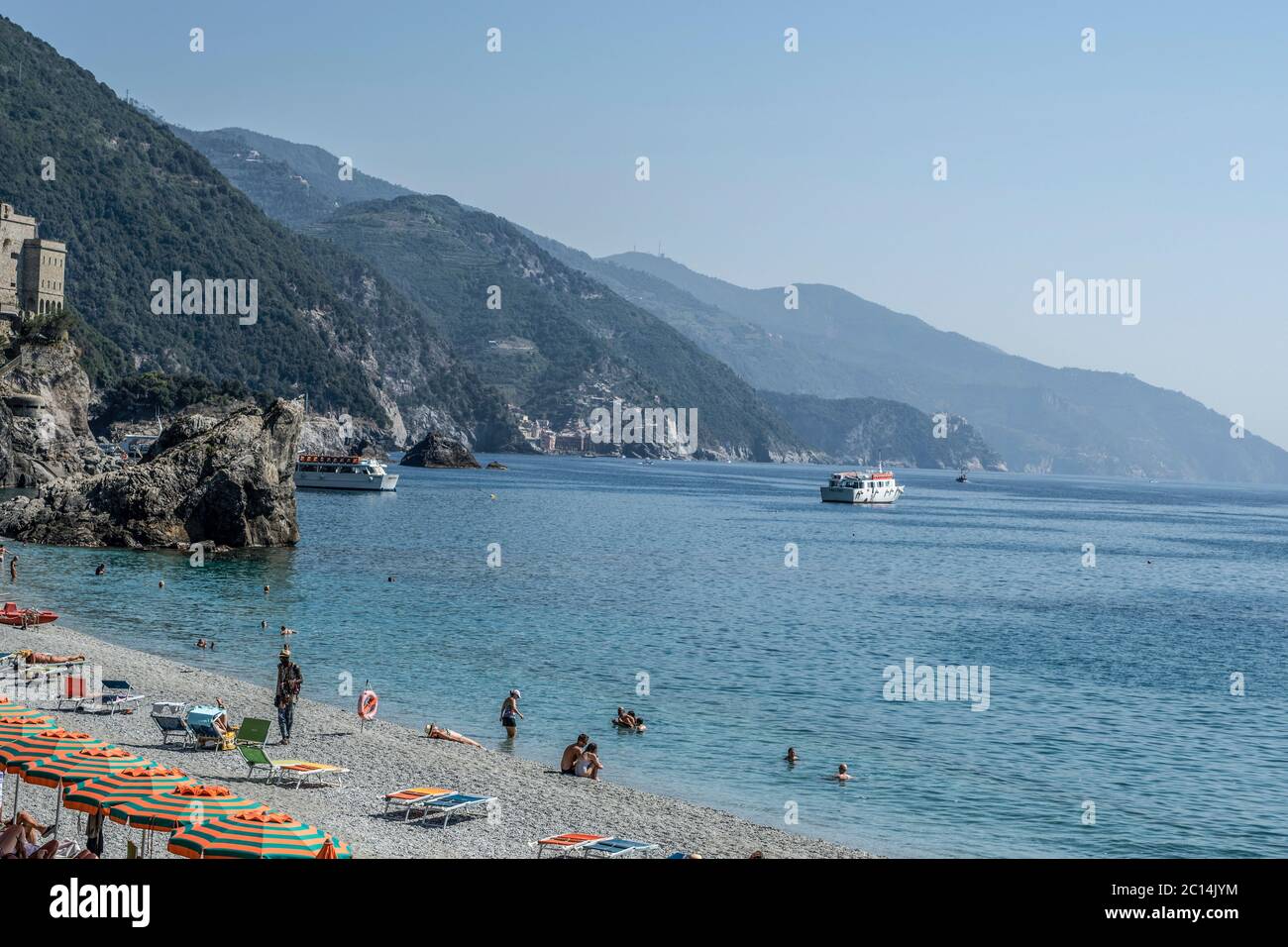 vacation beach with colorful rainbow chaise lounge chairs and umbrellas