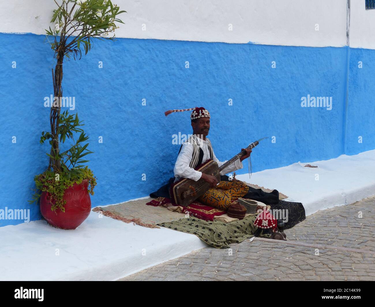Morocco, Chefchaouen a local man selling handwork in the street Stock Photo
