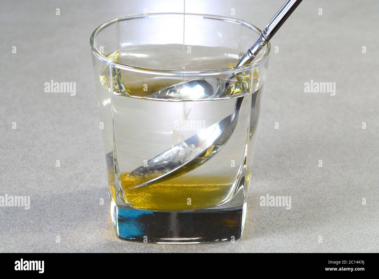 Mixing honey in water with the spoon Stock Photo Alamy