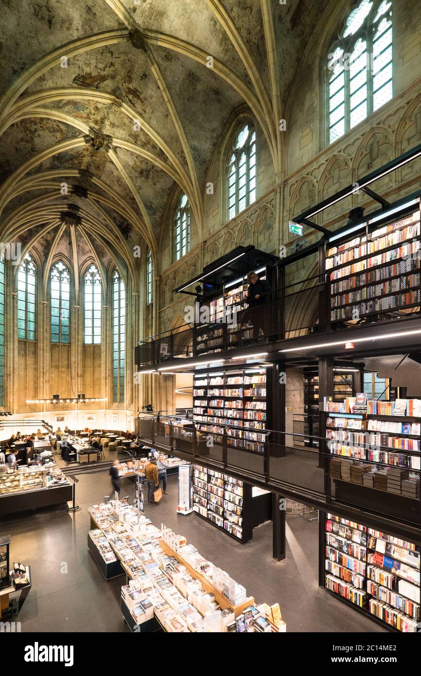 Interior of Dominican church converted into a bookstore with restaurant, customers, ceilings and pillars of the church in Maastricht, Netherlands Stock Photo