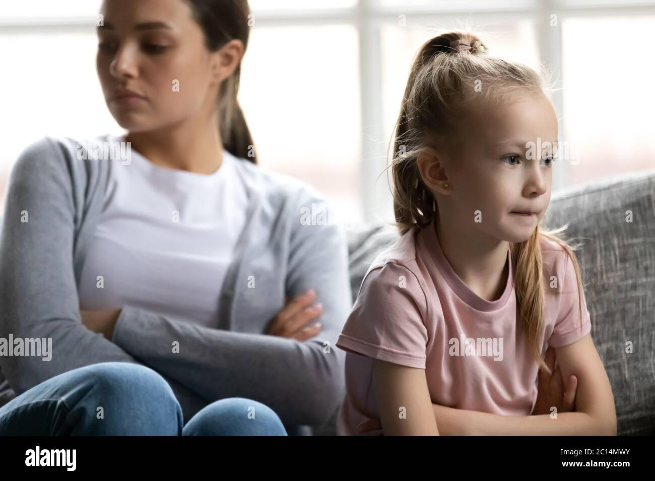 Close up upset little girl ignoring mother after quarrel Stock Photo