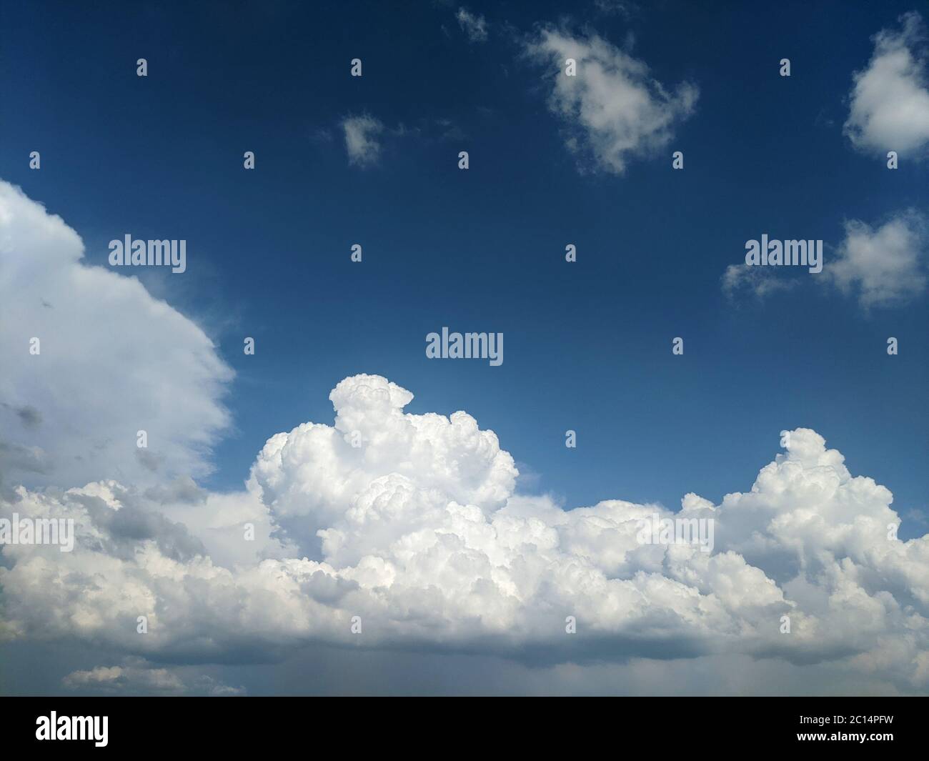 Fluffy clouds in blue sky on a summer day Stock Photo