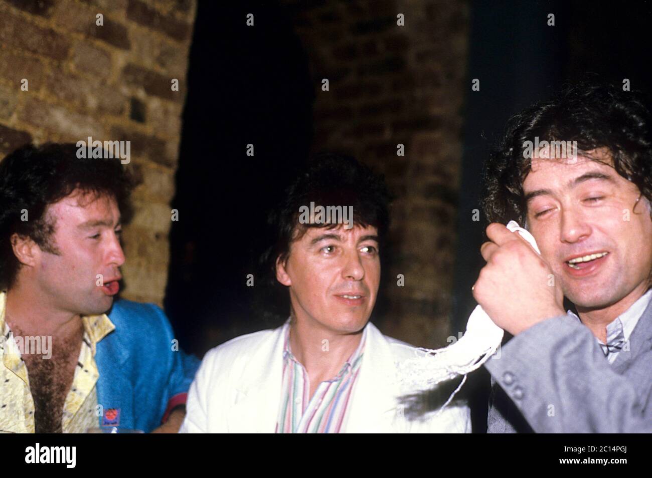 Paul Rodgers, Bill Wyman and Jimmy Page of Willie and the Poor Boys at a press event. London, April 18, 1985 | usage worldwide Stock Photo