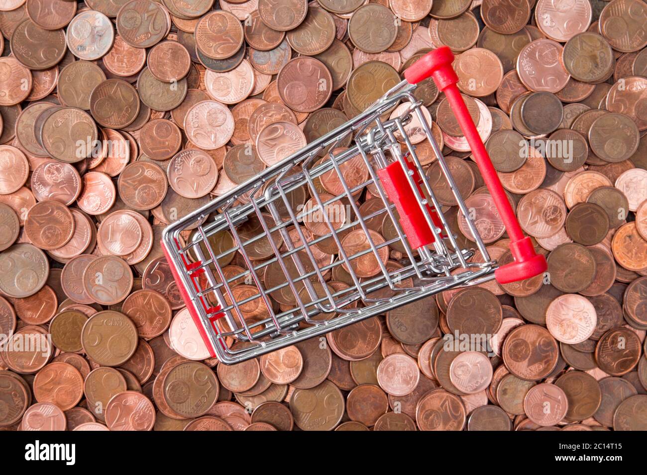 Euro cent coins and empty shopping cart Stock Photo