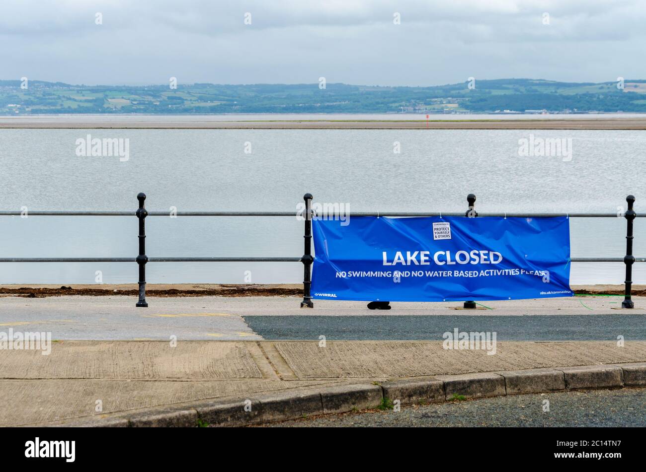 West Kirby, UK: Jun 3, 2020: A sign at Marine Lake advises that the lake is closed and no swimming or water based activities should take place Stock Photo