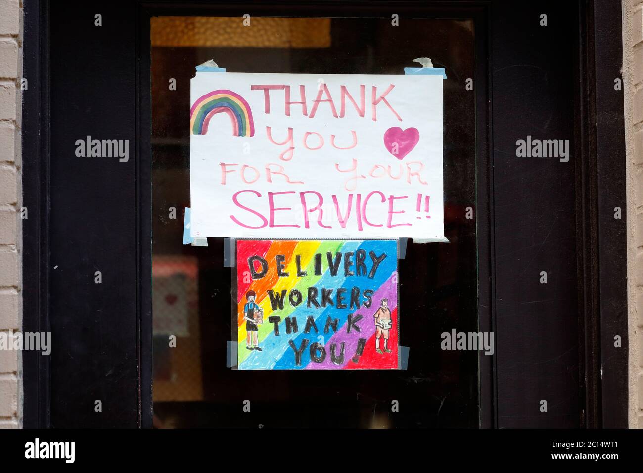 A 'Thank You Delivery Workers' sign at a door to an apartment building in New York, NY. June 7, 2020 Stock Photo