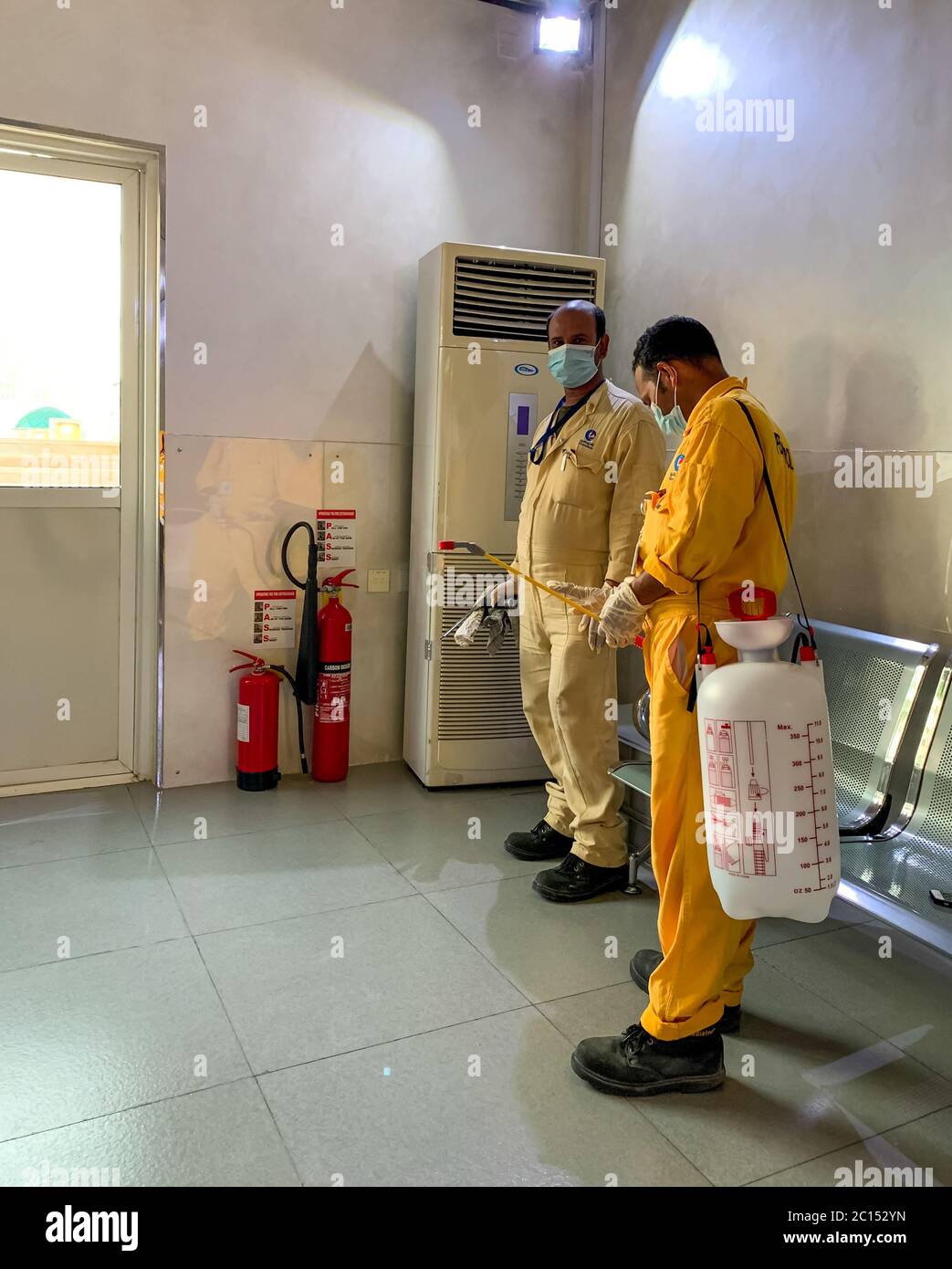 cleaner people in protective hand gloves and face mask, cleaning and disinfect covod-19, coronavirus disease, preventive measures Stock Photo