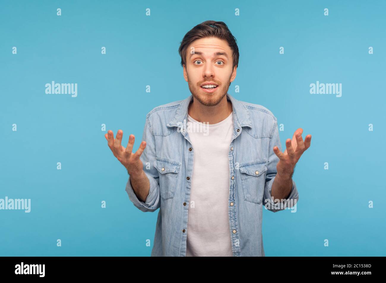 What do you want? Portrait of angry confused man in worker denim shirt ...