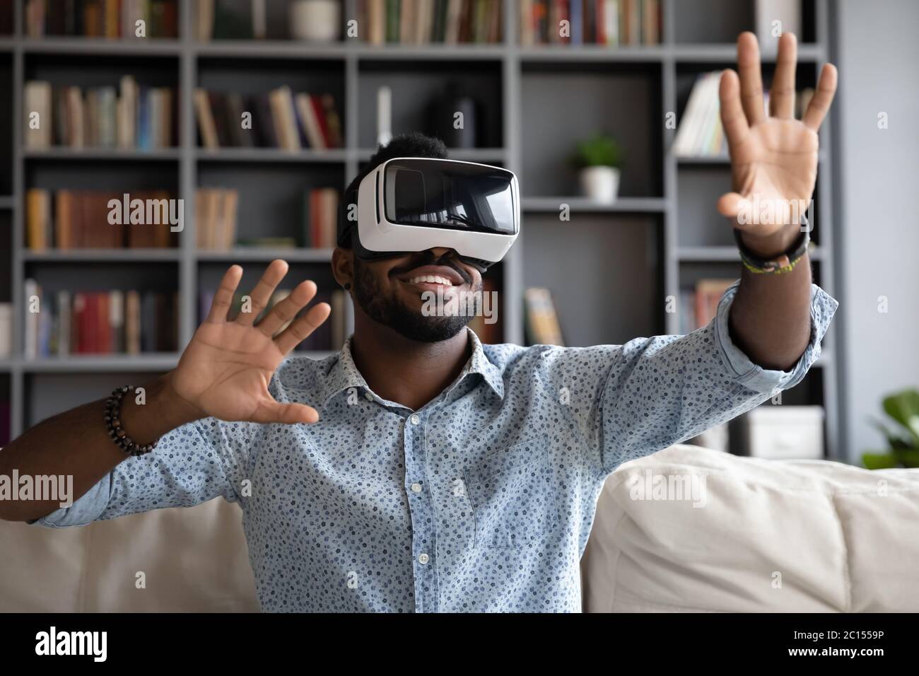 African guy wear headset enjoy virtual reality online game simulation Stock Photo