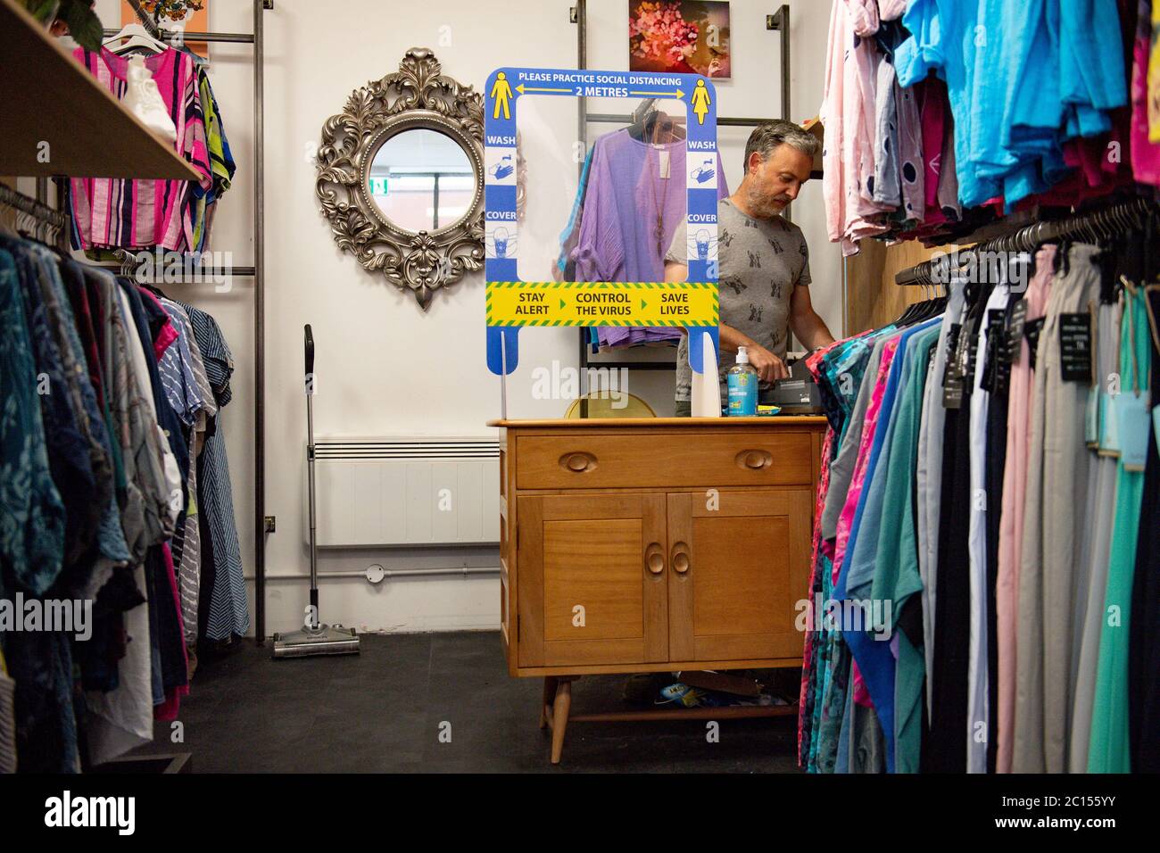 Retailer Clive Williams prepares his fashion store Pop Up Clothing Company  for customers in Stratford-upon-Avon, Warwickshire, ahead of the re-opening  of non-essential retailers in England on June 15 Stock Photo - Alamy