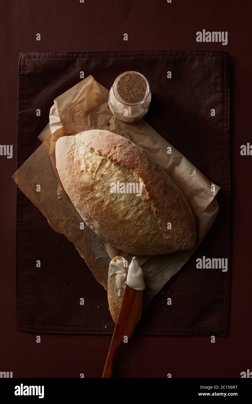 Loaf of bread over cooking paper Stock Photo