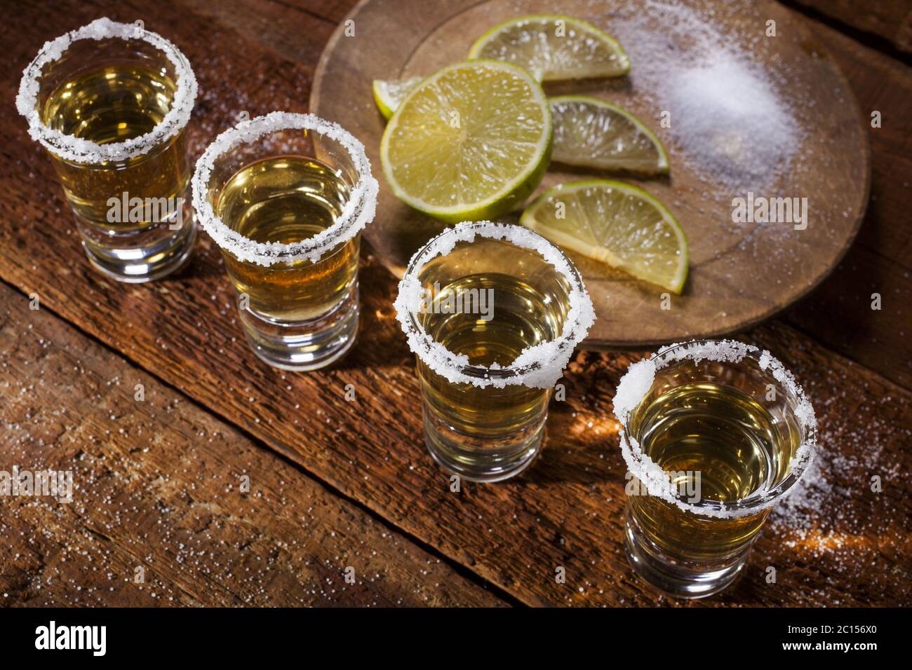 Tequila shots on wooden background Stock Photo - Alamy, image size:1300x956