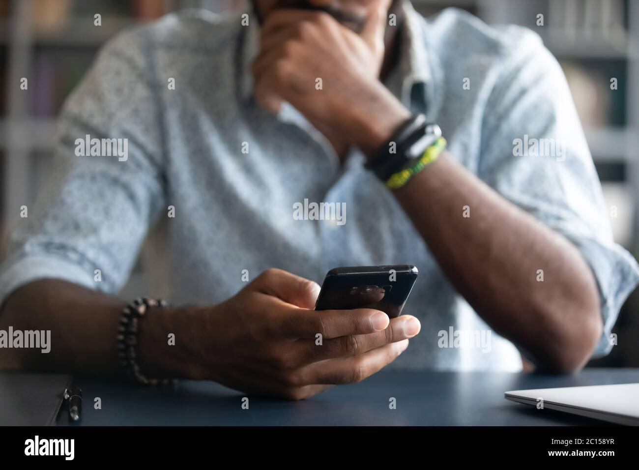 African guy holding smartphone closeup view hands and device Stock Photo