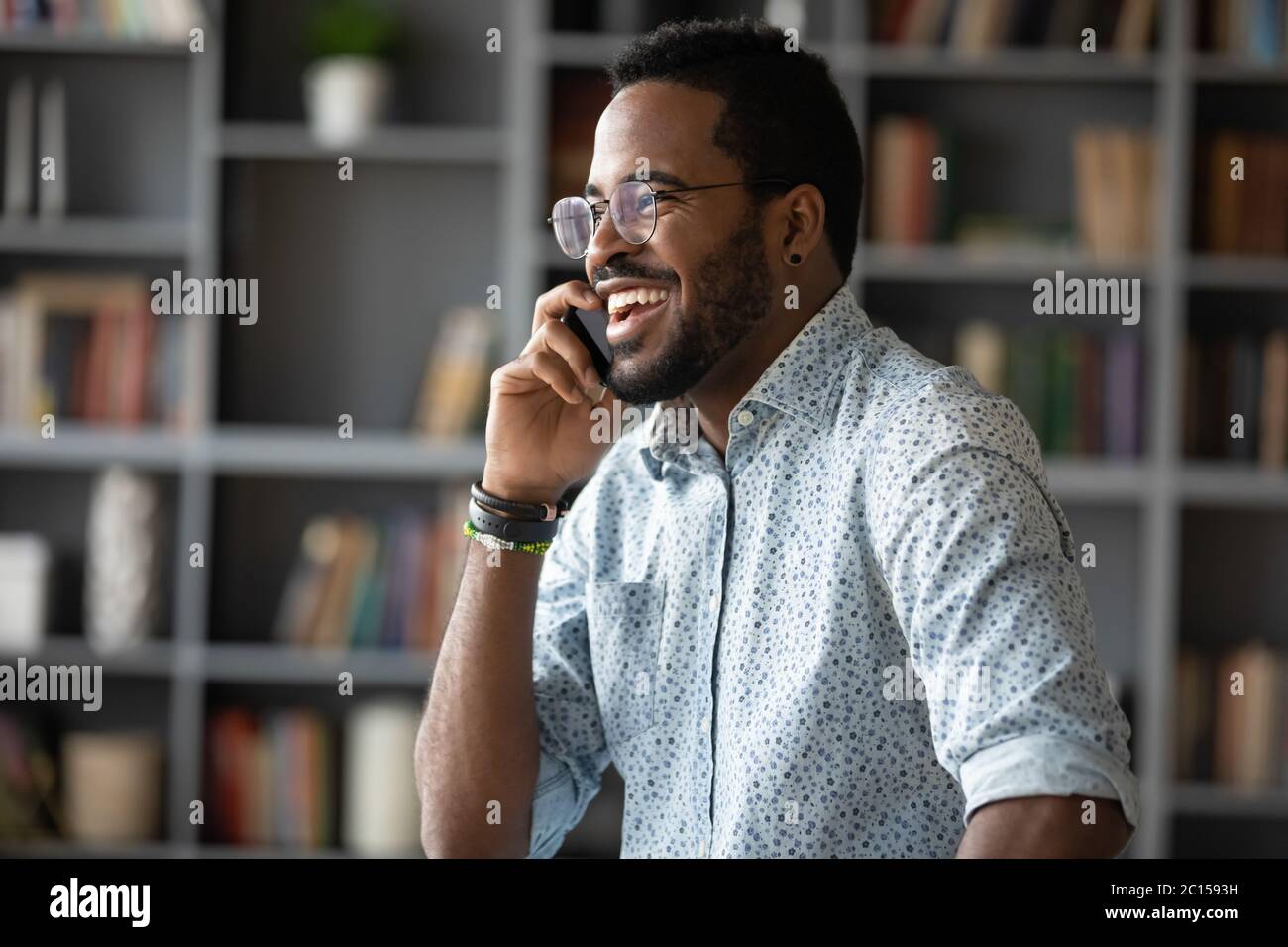 African businessman holding mobile phone enjoy informal conversation Stock Photo