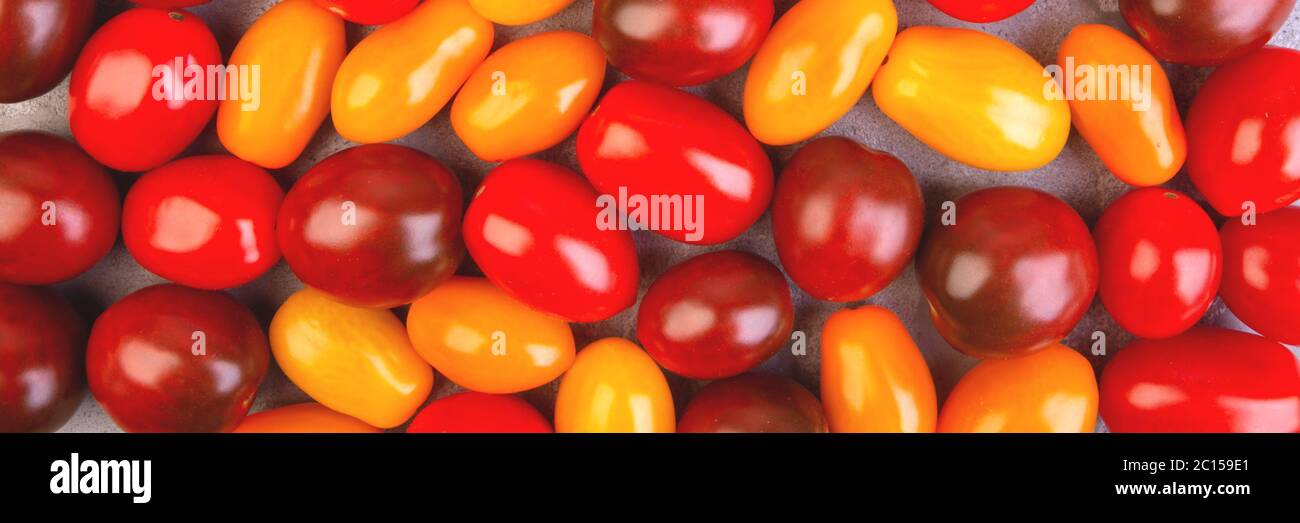 Cherry tomatoes on gray marble background. Banner. Stock Photo