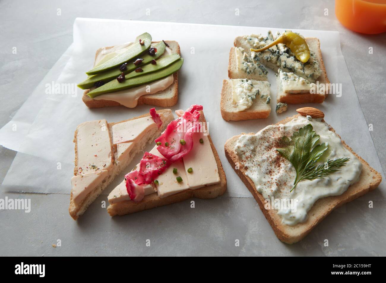 Sandwiches over white cooking paper Stock Photo