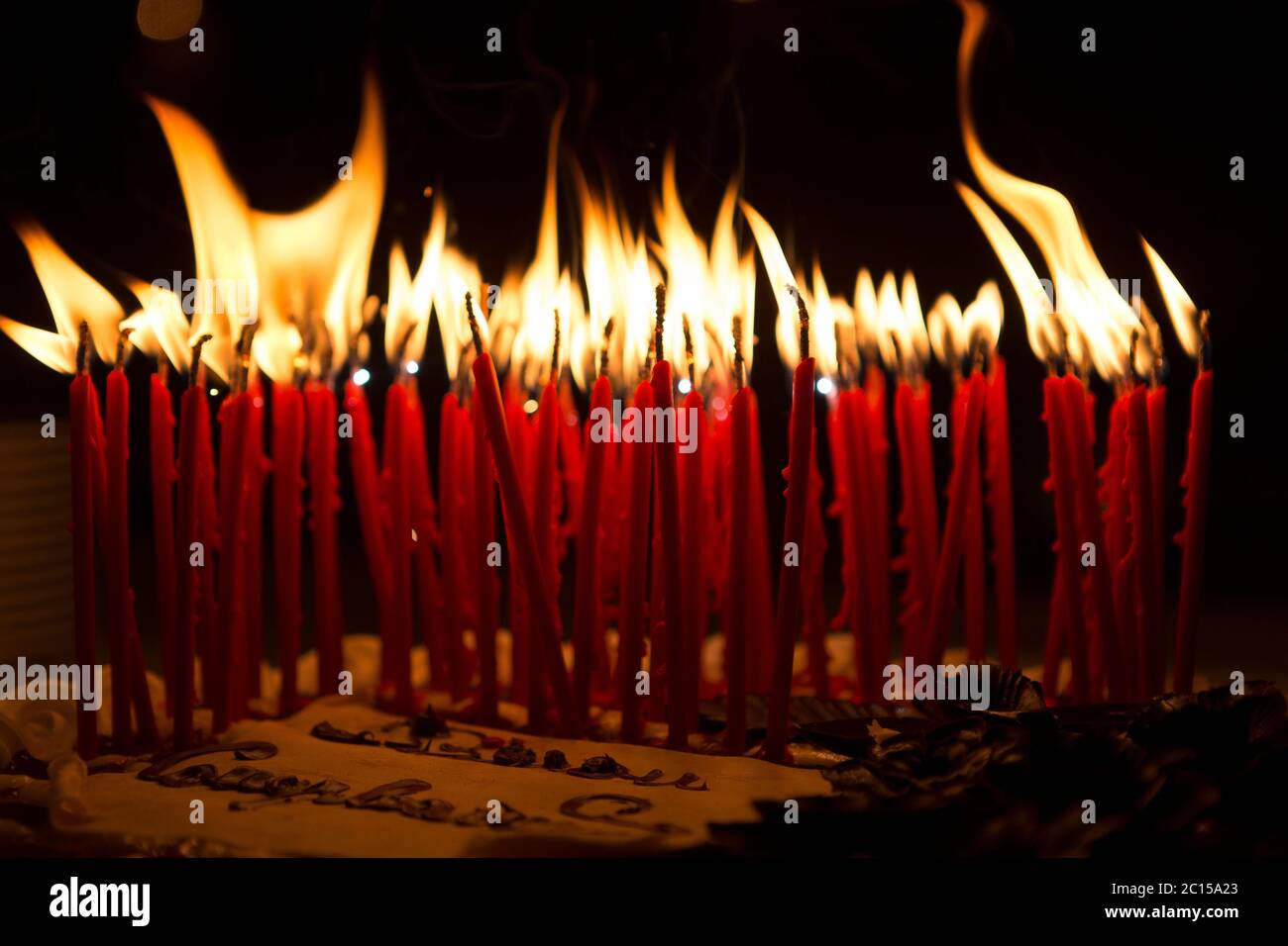 Detail of a birthday cake candles burning in a dark environment Stock Photo  - Alamy