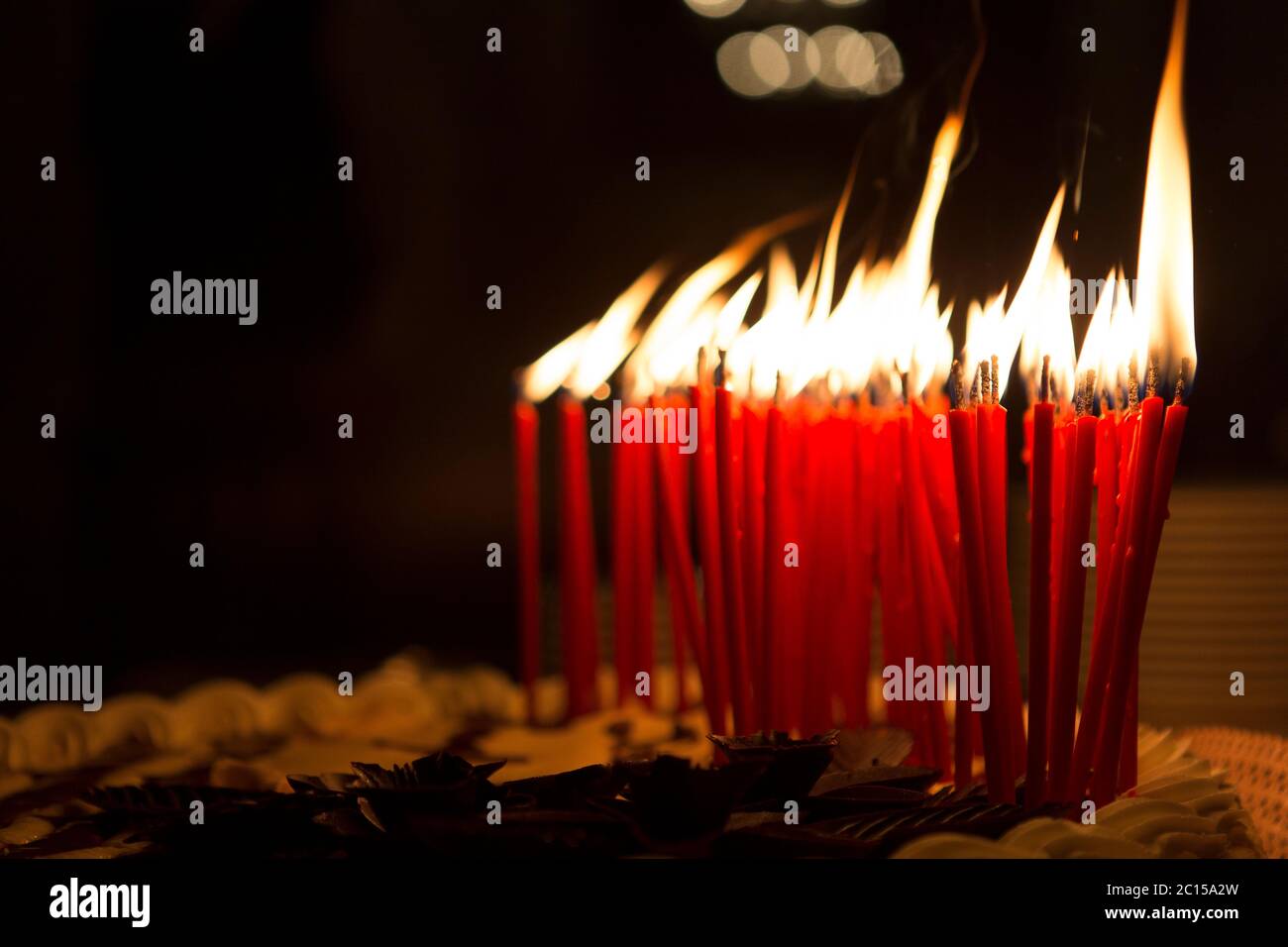 Detail of a birthday cake candles burning in a dark environment Stock ...
