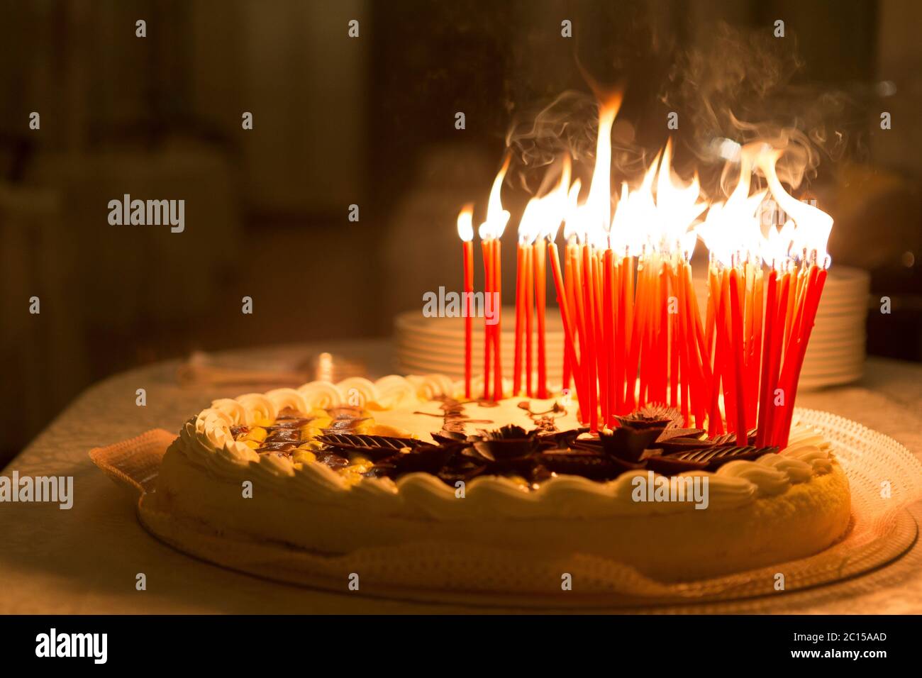 Detail of a birthday cake candles burning in a dark environment Stock ...