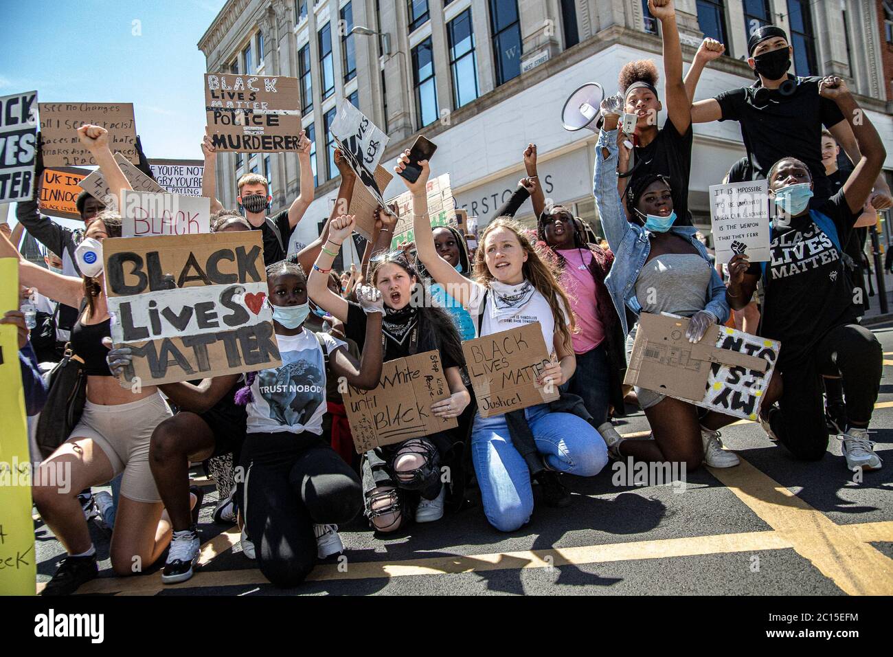 Brighton, UK. 13th June, 2020. A group of young people take a kneel in the street during the BLM protests in Brighton.Local activists in England organised a protest in the centre of Brighton in solidarity with the BLM protesters in the US to highlight the systemic racism and police brutality in the UK. Credit: SOPA Images Limited/Alamy Live News Stock Photo
