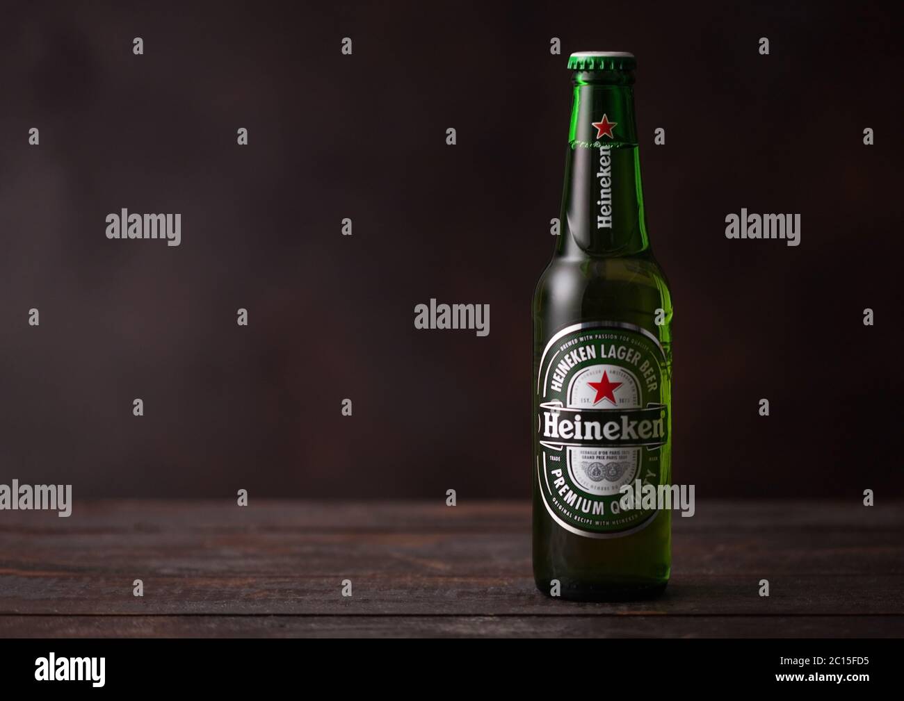 LONDON,UK - JUNE 01, 2020: Bottle of Heineken Lager Beer on dark wooden table background. Stock Photo