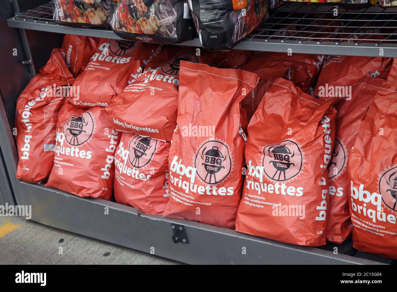 BBQ coal and Briquettes for sale outside garage Stock Photo