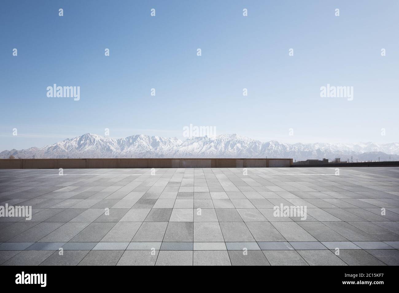 empty brick floor with white snow mountains Stock Photo