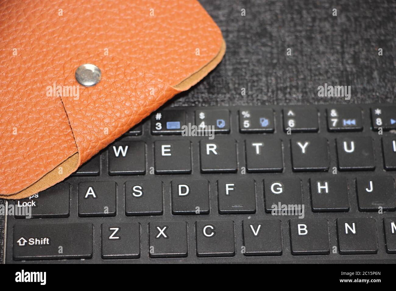 Brown leather wallet put on computer keyboard. Online business web ...