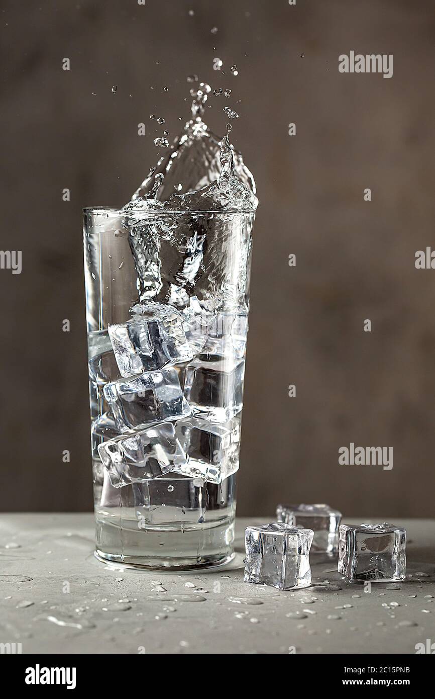 Splash in a glass with water and ice. Cool and thirstquenching drink