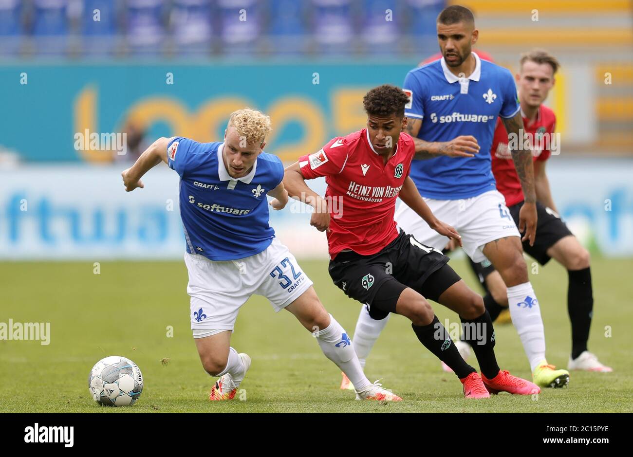 Darmstadt, Germany. 14th June, 2020. Football: 2nd Bundesliga, SV Darmstadt 98 - Hannover 96, 31st day of play in the Merck Stadium at the Böllenfalltor. Darmstadt's Fabian Holland (l) battles for the ball with Hannover's Linton Maina (2nd from left). Credit: Ronald Wittek/epa Pool/dpa - IMPORTANT NOTE: In accordance with the regulations of the DFL Deutsche Fußball Liga and the DFB Deutscher Fußball-Bund, it is prohibited to exploit or have exploited in the stadium and/or from the game taken photographs in the form of sequence images and/or video-like photo series./dpa/Alamy Live News Stock Photo