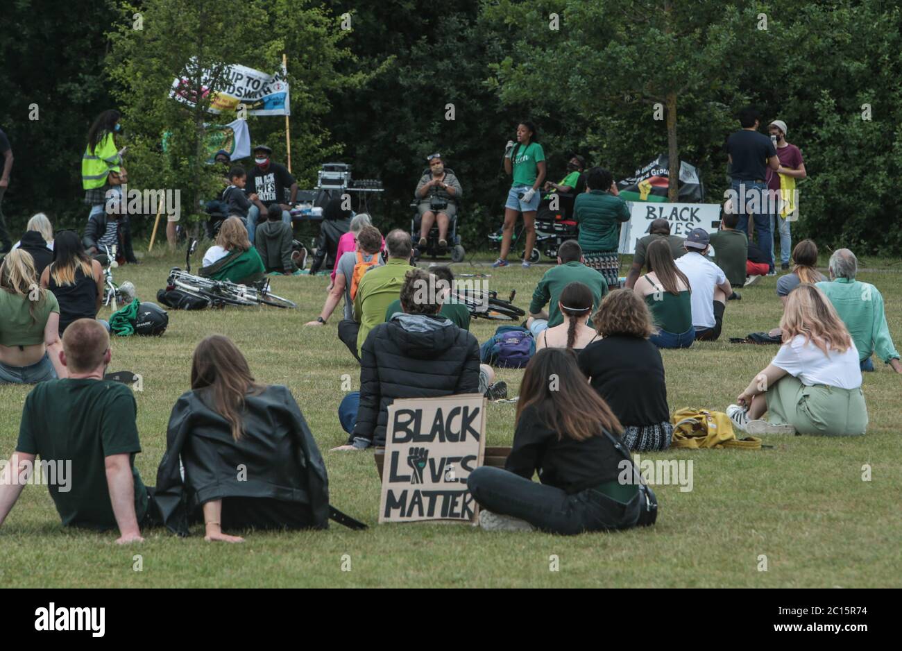 London UK 14 June 2020 Wandsworth Stand up to Racism and BLM , organised a peaceful protest on Tooting Common today. People who attended wore green as asked by the organisers to remember the 3rd anniversary of the fire at Greenfell, and a candle was lighted for those who died. Paul Quezada-Neiman/Alamy Live News Stock Photo