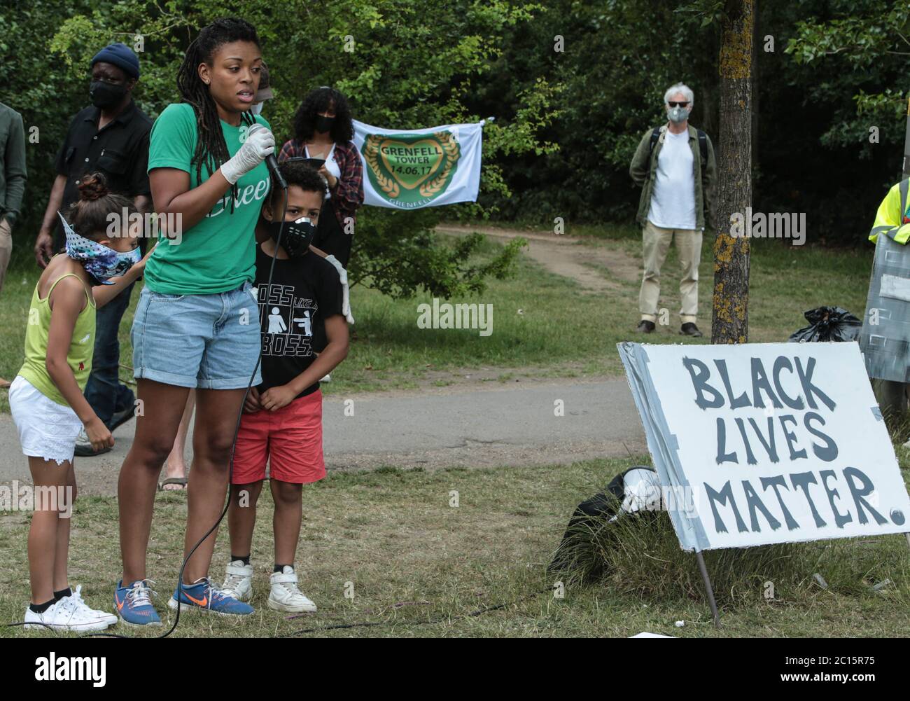 London UK 14 June 2020 Wandsworth Stand up to Racism and BLM , organised a peaceful protest on Tooting Common today. People who attended wore green as asked by the organisers to remember the 3rd anniversary of the fire at Greenfell, and a candle was lighted for those who died. Paul Quezada-Neiman/Alamy Live News Stock Photo