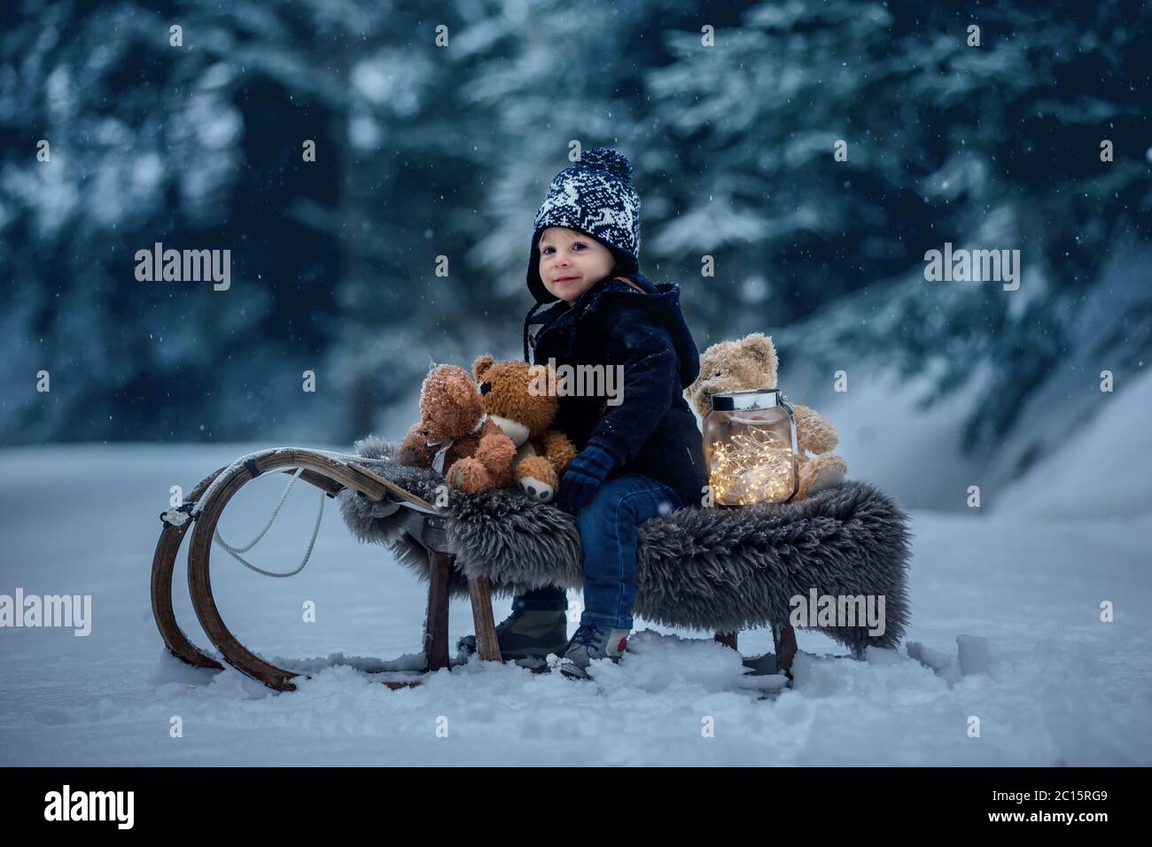 Cute boy playing with teddy bear in the snow, winter time. Little ...