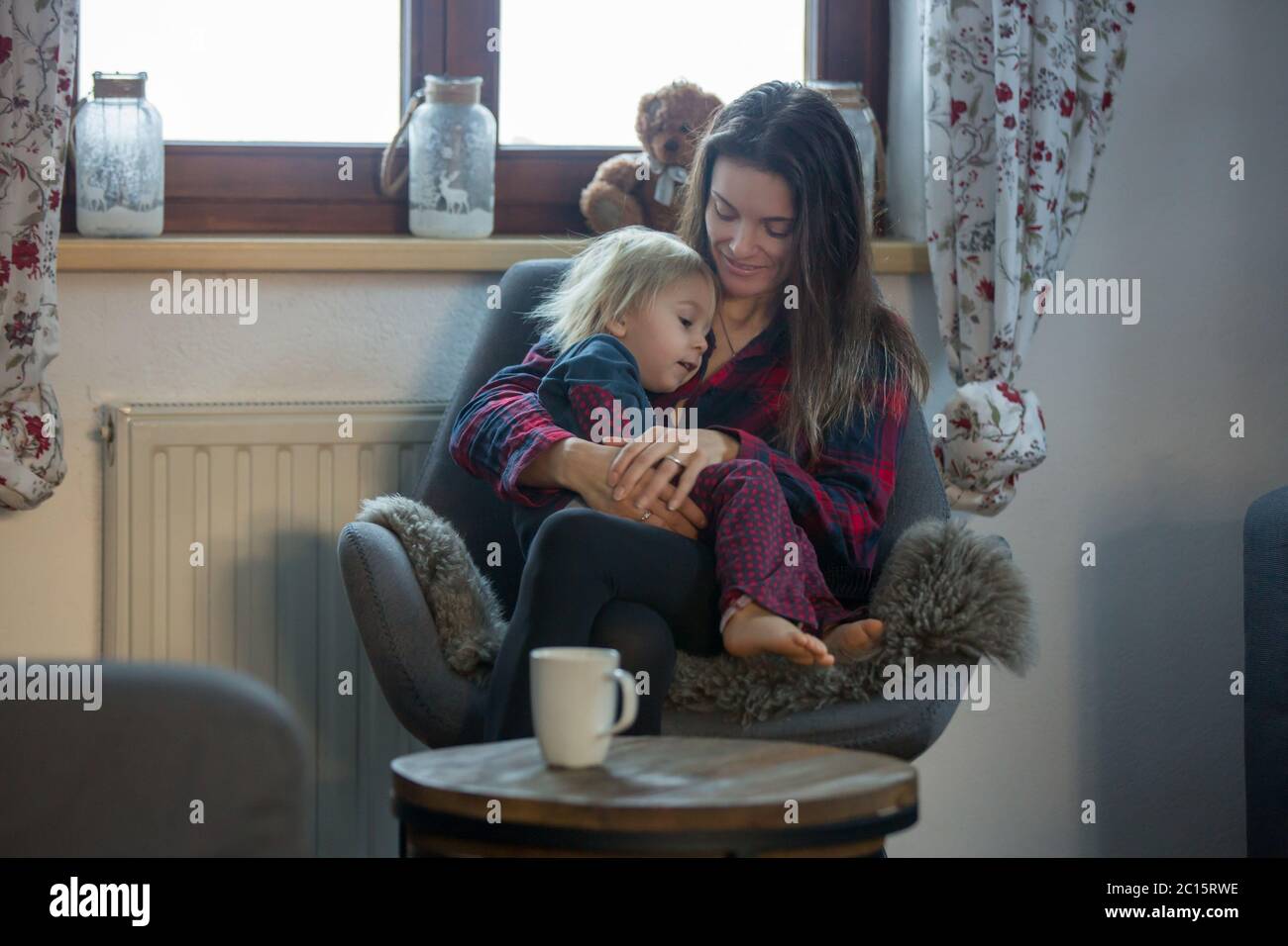 Mother and child, sitting in rocking chair, hugging Stock Photo Alamy
