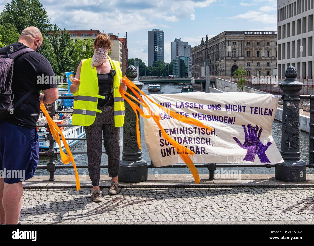 Mitte, Berlin,Germany. 14th June 2020. Unteilbar Demo, Indivisible Protest. Tens of thousands of people formed 9 kilometre long human chain between the Brandenburg Gate and Hermannplatz, The demonstrators were  demonstrating against exclusion and racism as well as for solidarity and a social and climate-friendly future. The participants used plastic tapes to keep a two meter distance apart during the Corona Virus pandemic.credit: Eden Breitz/Alamy Stock Photo