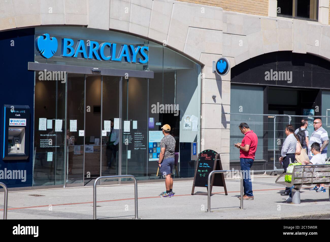 Barclays bank branch with people queuing and socially distancing due to coronavirus, Southampton Stock Photo