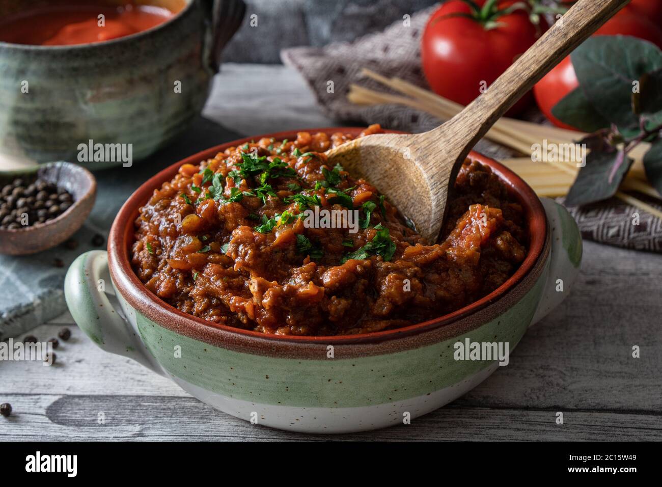 Bolognese tomato and beef sauce in rustic bowl. Traditional Italian sauce used for pasta. Stock Photo