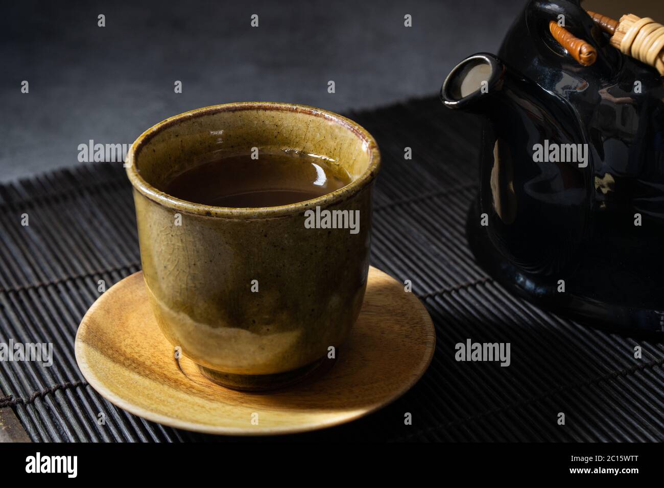 Japanese green tea in a traditional and beautiful clay cup. Japanese dishes and tableware. Stock Photo