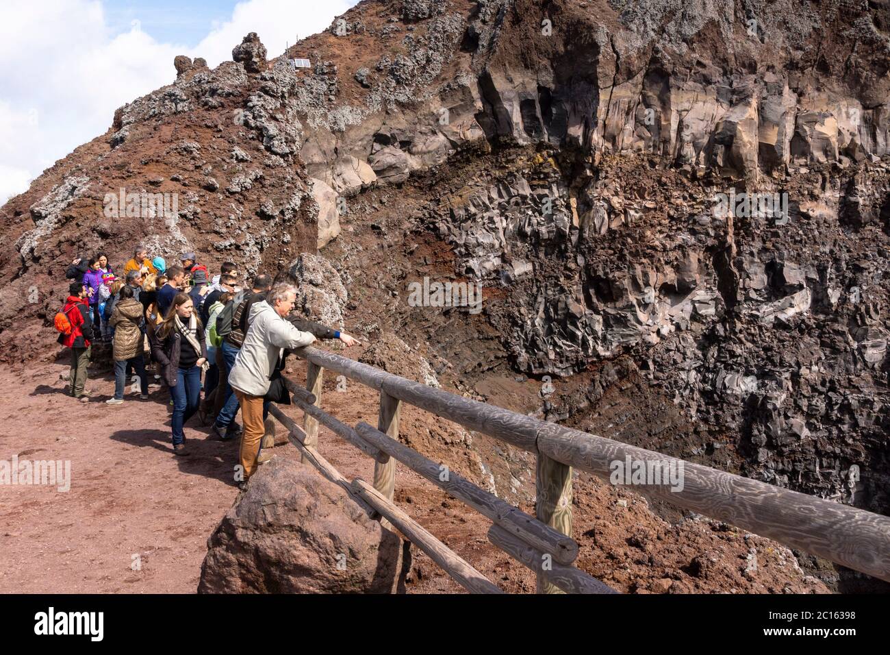 Tourists and visitors at the peak / cone on the edge of the summit caldera of Mount Vesuvius, an active volcano (somma-stratovolcano), Campania, Italy Stock Photo