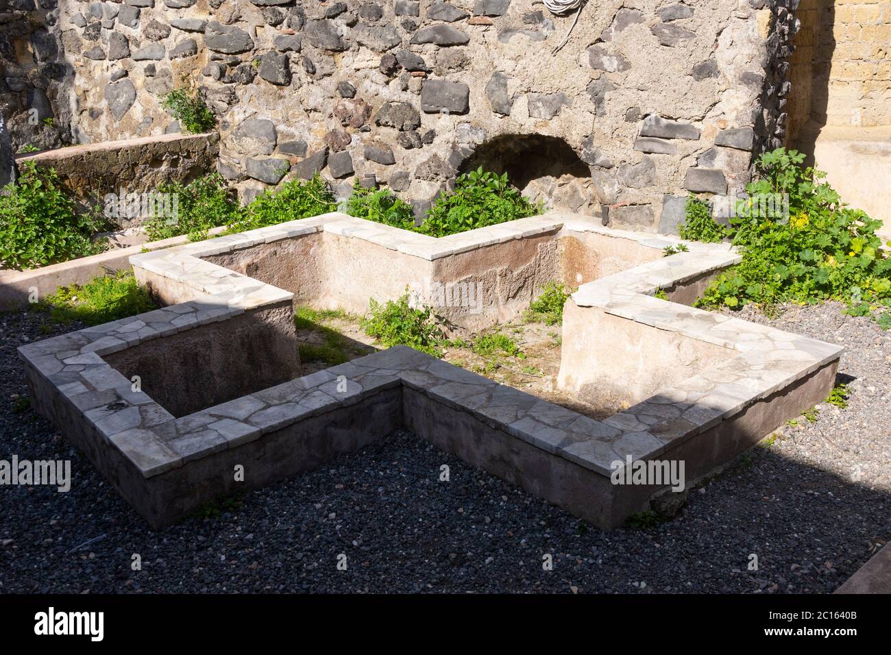 A cruciform or cross shaped marble Roman piscina in Peristyle 10 in the Casa di Galba (House of Galba), ancient city of Herculaneum, Italy Stock Photo