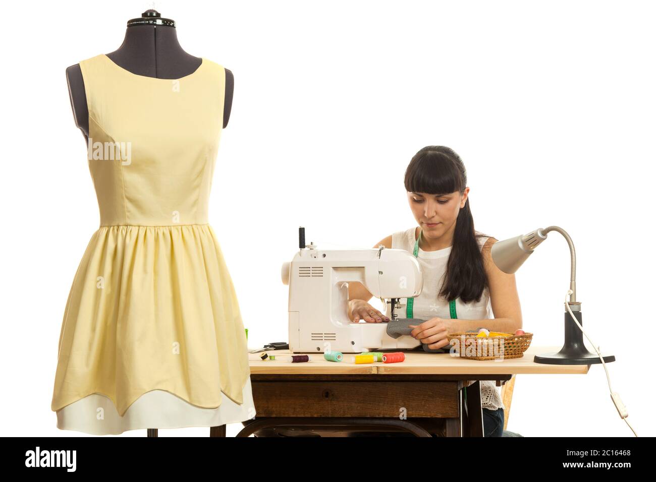 the seamstress sews a product on a table Stock Photo