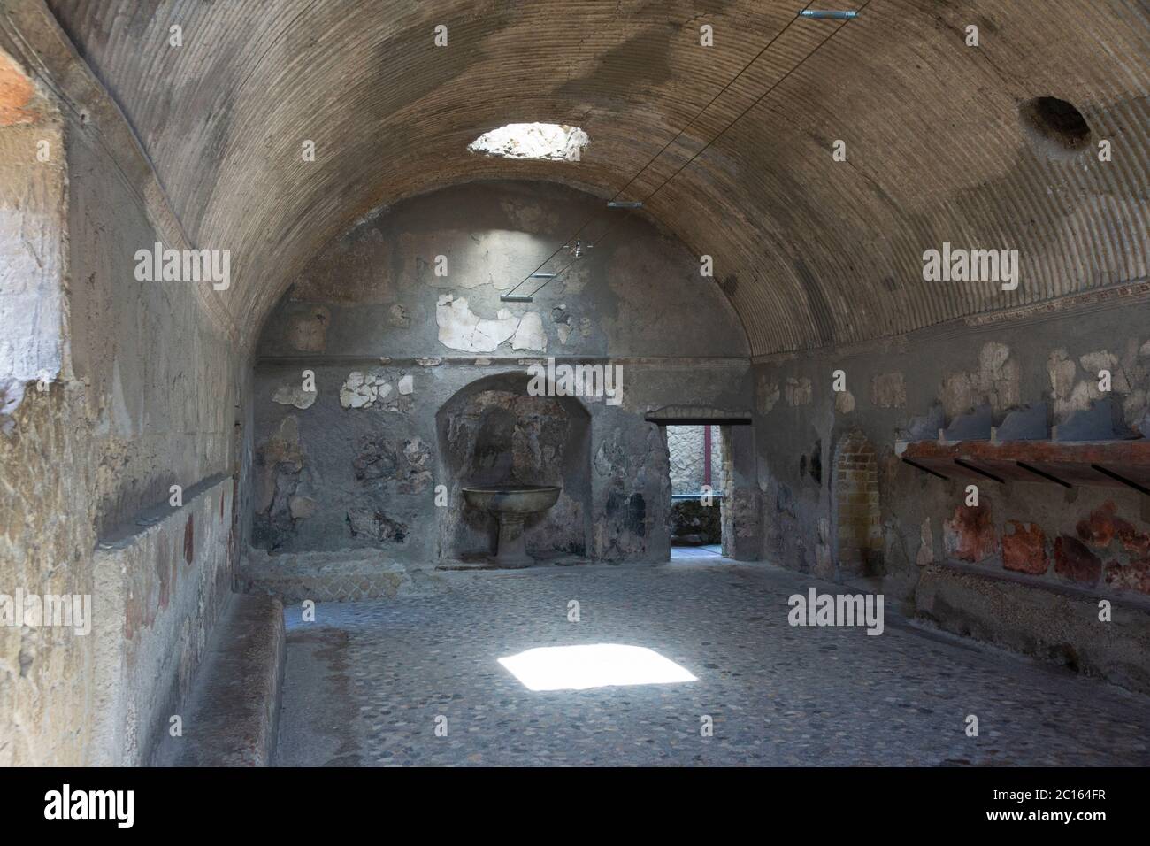 The Apodyterium (changing room) in the Roman baths has a vaulted ceiling decorated with stucco, the floor is paved in opus scutulatum. Herculaneum Stock Photo