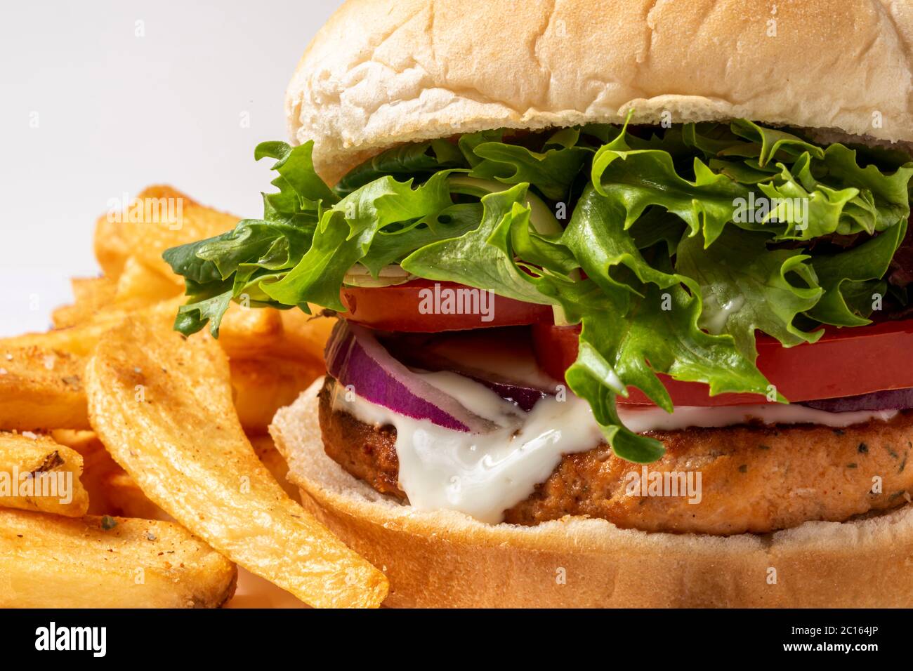 Salmonburger with home cooked oven baked fries Stock Photo Alamy