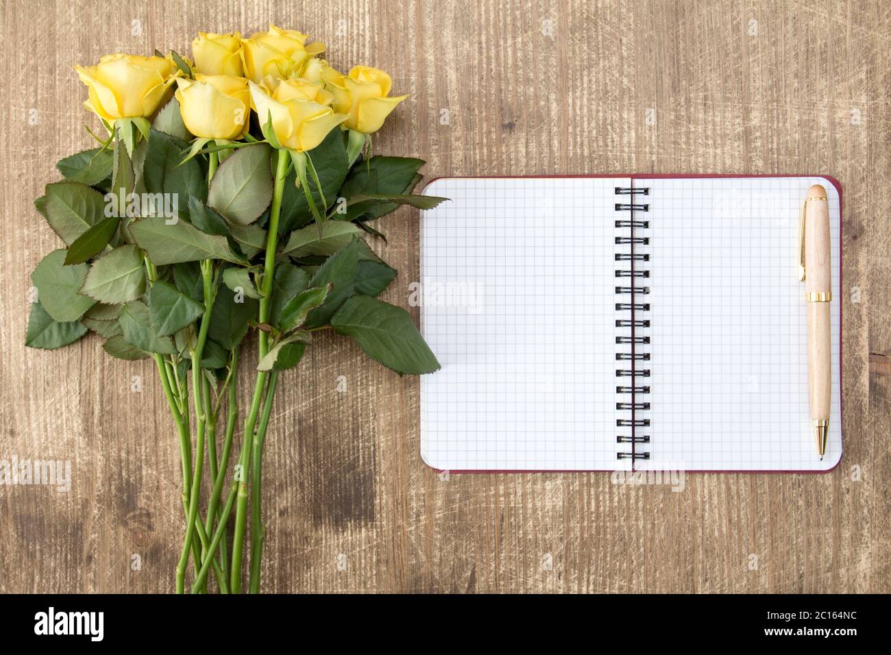 Blank notebook and bunch of yellow roses Stock Photo